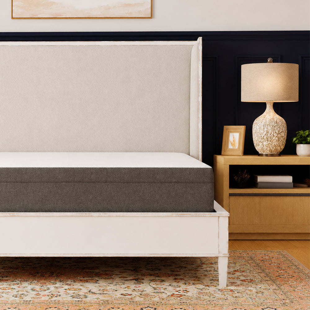 South Bay Rose 10-inch medium gel-infused mattress shown on a white classic bed frame in a luxury bedroom setting with navy blue walls.
