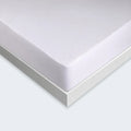 Close-up of BEDGEAR Stretchwick mattress protector with a secure fit and moisture-wicking white fabric.
