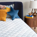 Close-up of the soft, quilted plush pillow top on the Serta Perfect Day 10 inch mattress for pressure relief.
