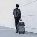 Travel-ready BEDGEAR Storm cooling pillow bag secured to a suitcase handle for convenient commuting or flying.
