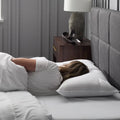 Side sleeper using the Malouf Z pillow for ergonomic neck alignment and plush microfiber support.
