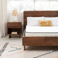 Supportive Ashley Sleep 6 inch mattress on a dark wood platform bed for a minimalist, comfortable bedroom.