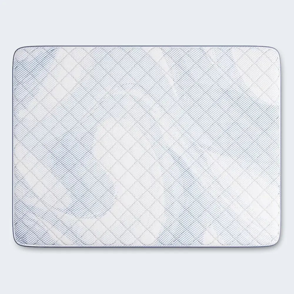 Top view of the textured, diamond-quilted white surface on a Serta Perfect Day firm mattress.
