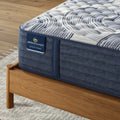 Close-up of Serta Perfect Sleeper Pro quilted hybrid mattress corner showing the 14 inch medium profile texture.

