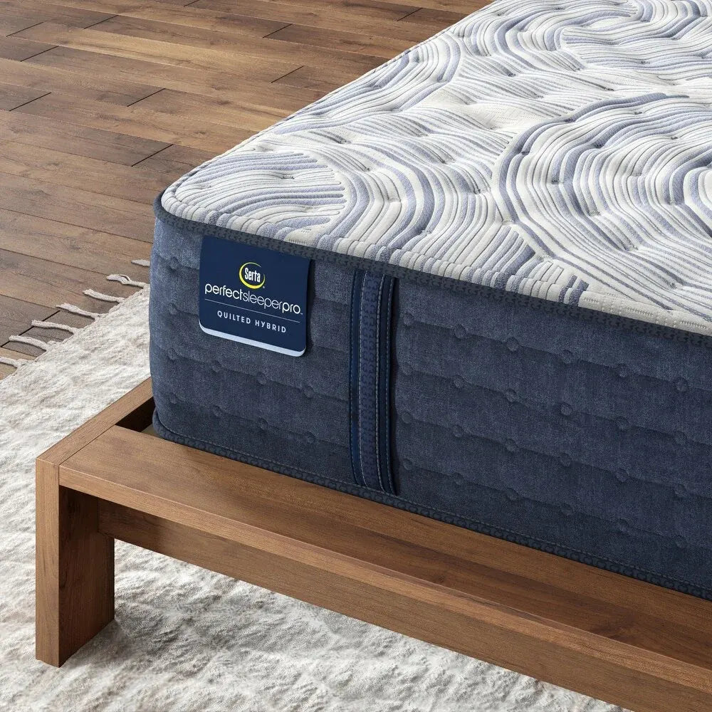 Close-up of Serta Perfect Sleeper Pro Kensington Hybrid Mattress fabric on a wooden frame.
