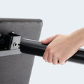 Close-up of the tool-free assembly process for the Weekender 50 Series adjustable base showing a screw-in leg.
