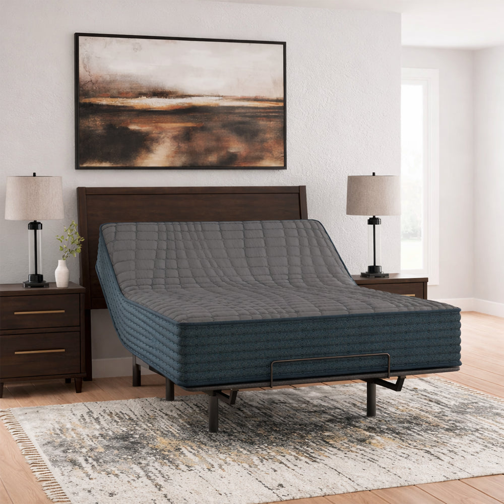 Spacious bedroom setting with the Gray 1200 Hybrid firm mattress on an adjustable base, perfect for ergonomic sleep and relaxation.
