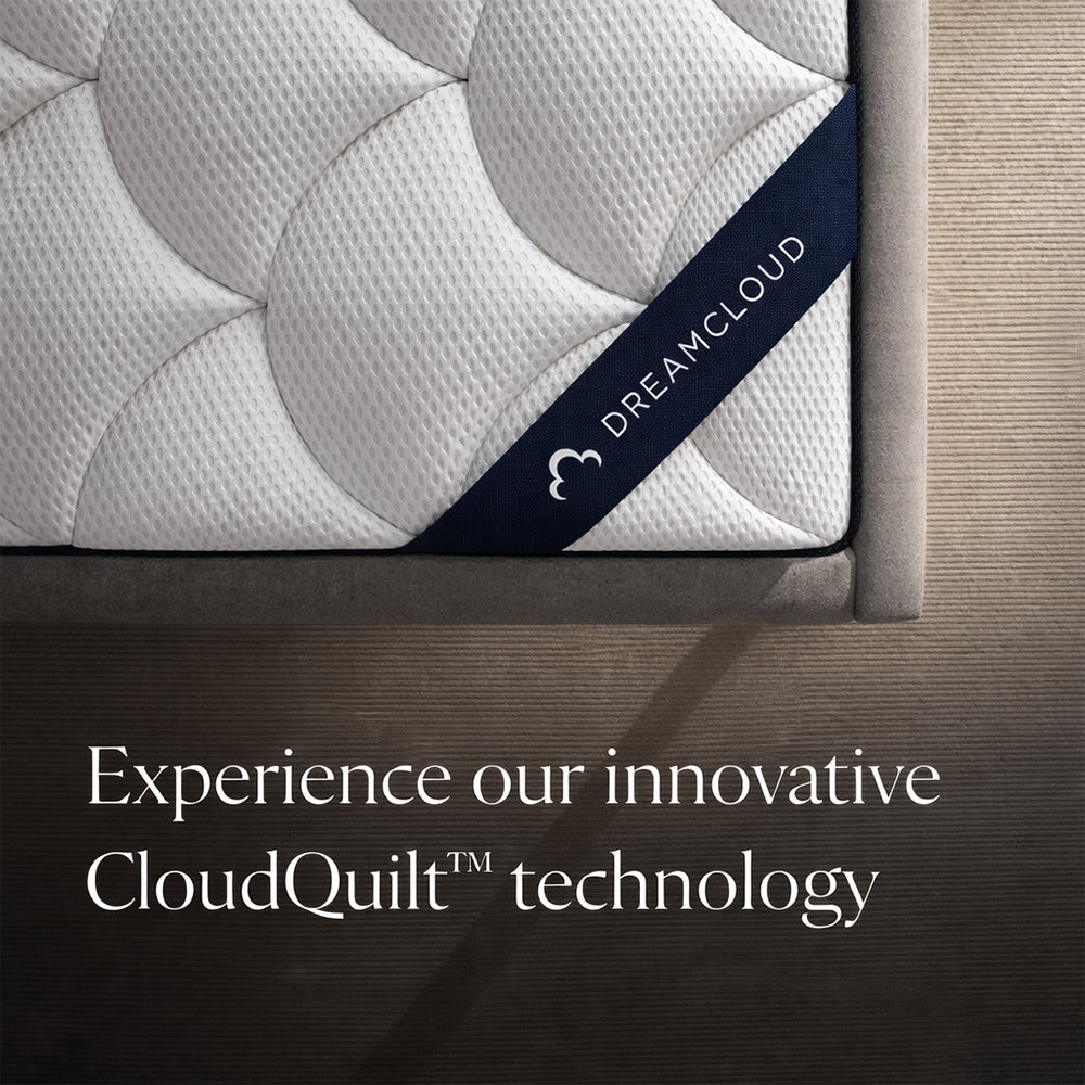 Top-down corner detail of the DreamCloud Classic mattress featuring the signature branded strap and innovative CloudQuilt technology fabric.