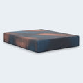 Side-angle view of the Hot Buy 13-inch Firm Hybrid Mattress featuring a modern pixelated blue and peach cooling cover design.
