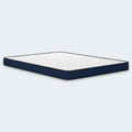 Perspective studio shot of the Ashley Firm 6-inch low-profile mattress showcasing the durable quilted top and reinforced navy border