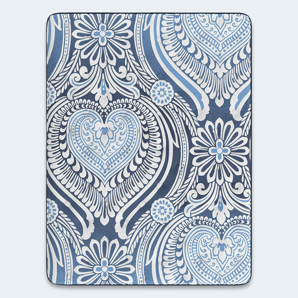 Overhead top-down view of the Luxe 2.0 Blue 15-inch mattress surface featuring a sophisticated blue and white heart damask pattern.
