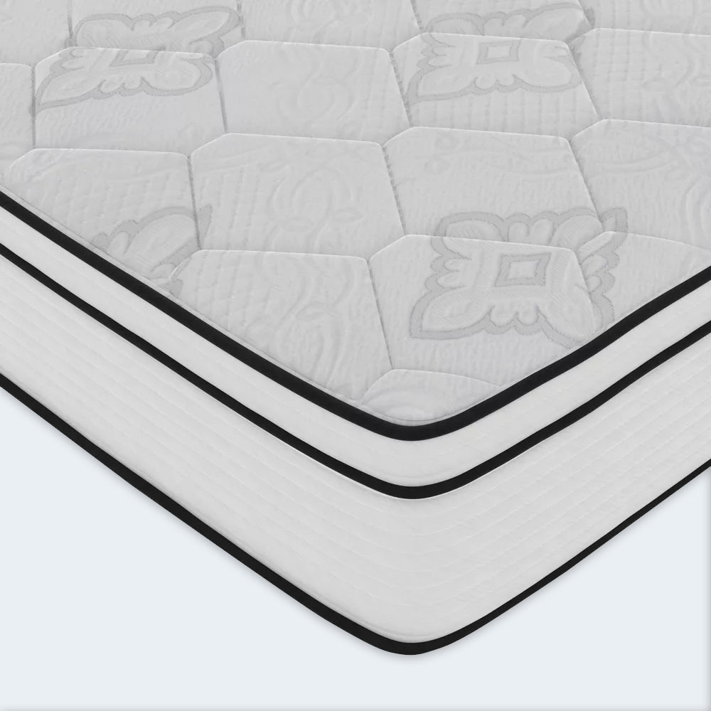Detailed corner shot of the American Bedding Cymbal Jingle 10-inch mattress featuring a white quilted surface and black piped edges.
