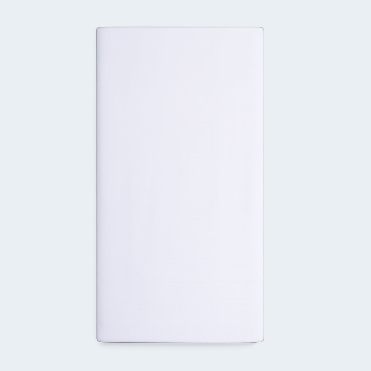 Top view of the Basic Kids Mattress Protector displaying the smooth, clean white surface and rectangular shape.