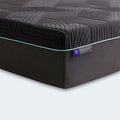 Close-up corner of the Ice Cloud 13" ActivAir Hybrid Mattress showing the purple logo tag and thick cooling fabric.