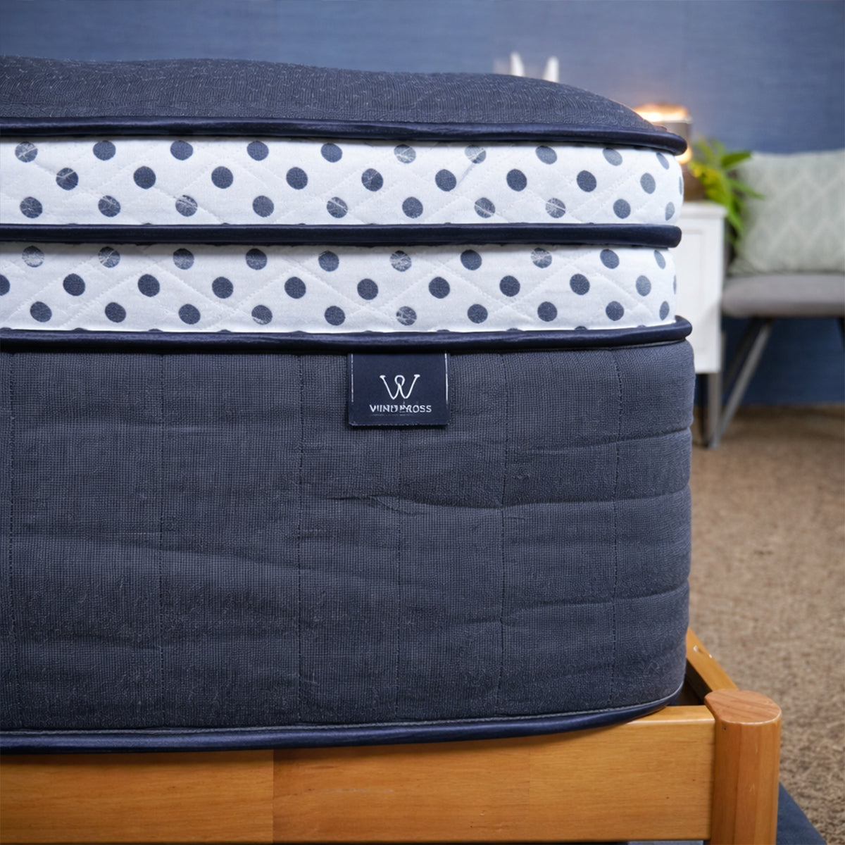 Close-up of the WinkBeds Blue Mattress brand label and the signature polka dot gusset on the double box top.