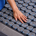 Hand testing M3 Performance Modular Hybrid Mattress internal coil units to demonstrate independent modular support.