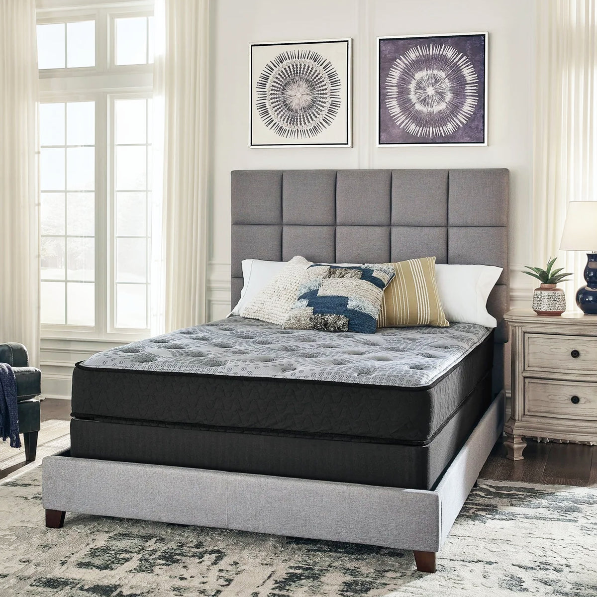 Front view of the Comfort Plus 10 Inch Medium Mattress positioned on a grey platform bed with a matching headboard.