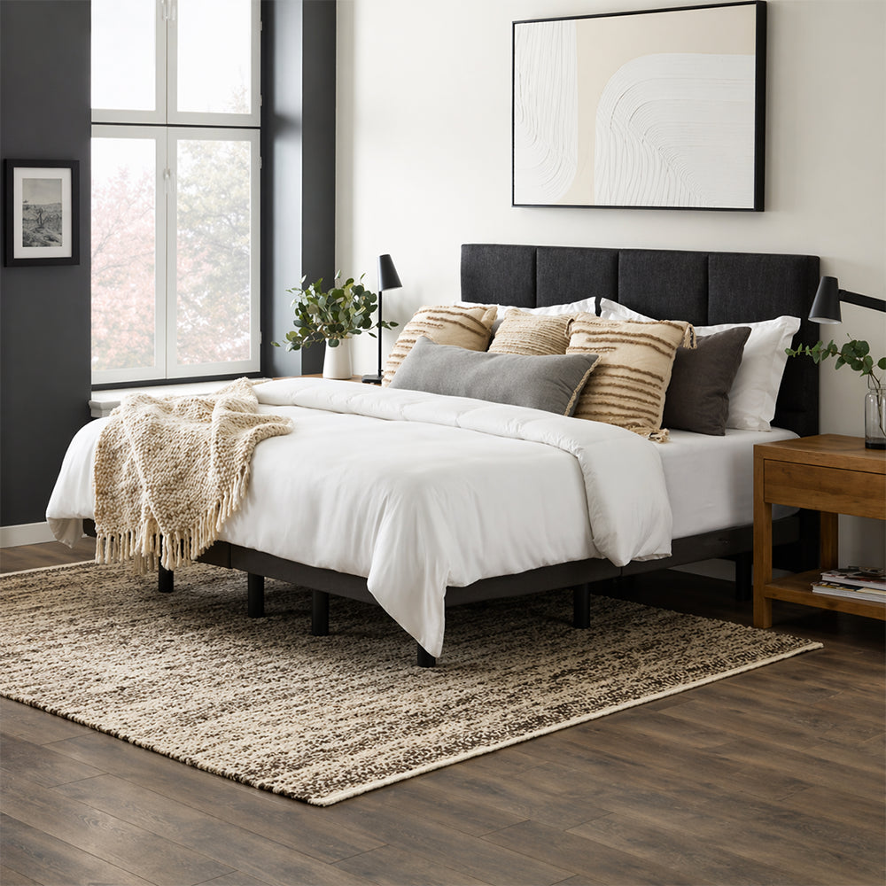 Fully dressed bed with white bedding and a charcoal headboard featuring the hidden Malouf M455 adjustable base system.