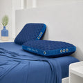 Pair of BEDGEAR Night Ice cooling pillows on a bed, providing temperature-regulated support for a restful sleep.
