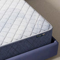 Close-up of the Serta Perfect Day mattress border and logo, highlighting the durable firm construction.
