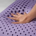 Hand pressing Malouf lavender dough memory foam showing breathable zoned ventilation and plush support.
