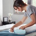Woman putting a removable machine-washable cover on a Malouf Weekender gel memory foam pillow.
