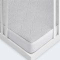 Corner view of a light gray Air-X crib mattress protector by BEDGEAR for superior airflow and protection.