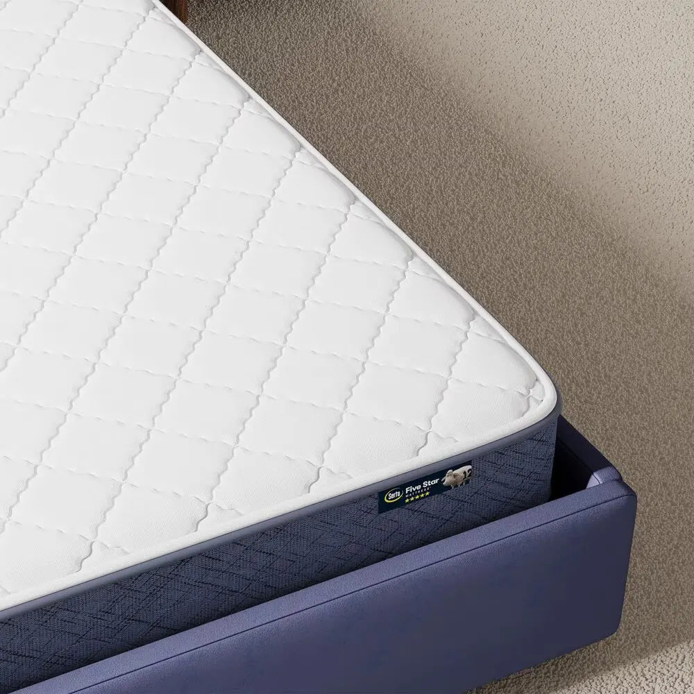 Close-up of the quilted top and Serta brand label on the 7 inch firm mattress for back support.
