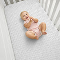 Happy baby on a BEDGEAR Ver-Tex crib mattress protector, providing a breathable and temperature-neutral sleep.
