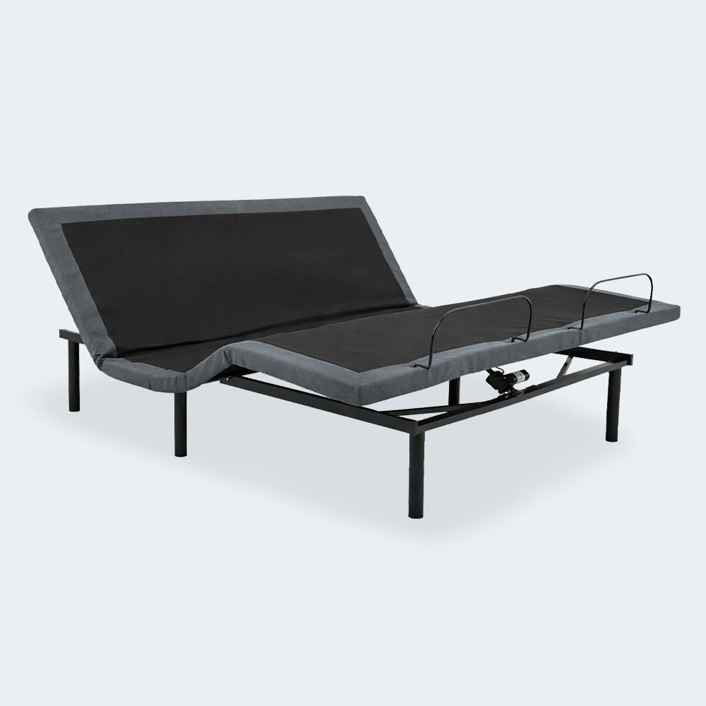 Perspective view of the Customatic Opus adjustable bed in an ergonomic lounging position with head and foot sections raised.
