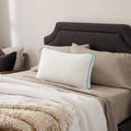 Malouf FlexFill pillow with HyperChill cooling cover styled on a neutral bed with plush white bedding.

