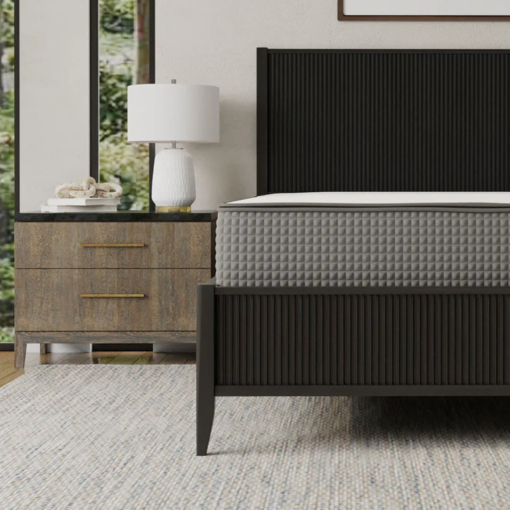 Close-up detail of the iSwitch mattress on a designer platform bed, showcasing the high-quality quilted cover and modern bedroom decor.
