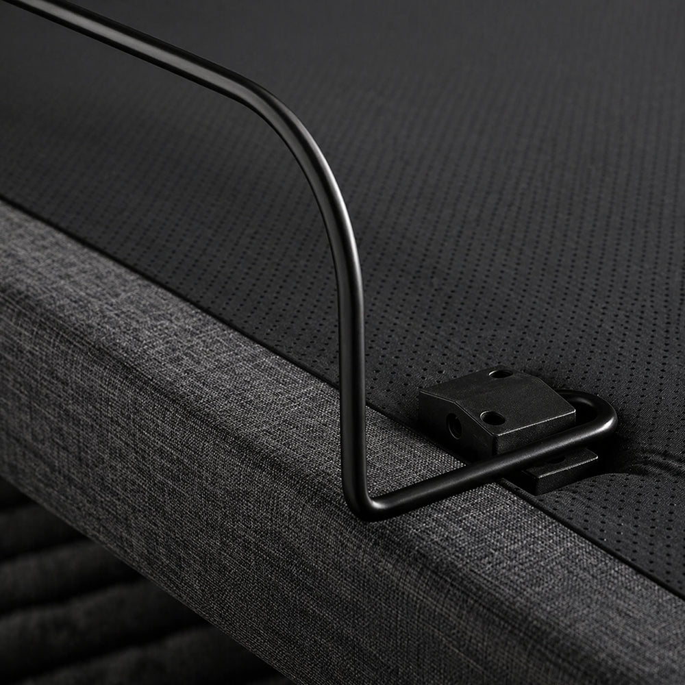 Close-up of the secure mattress retainer bar on a grey upholstered SleepTone adjustable base designed to prevent mattress shifting during incline.
