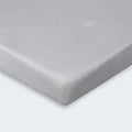 Detailed corner view of a grey moisture-wicking Hyper-Linen crib sheet by BEDGEAR.
