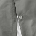 Clear button closure detail on the charcoal grey pinch pleat comforter for a high-quality, durable finish.
