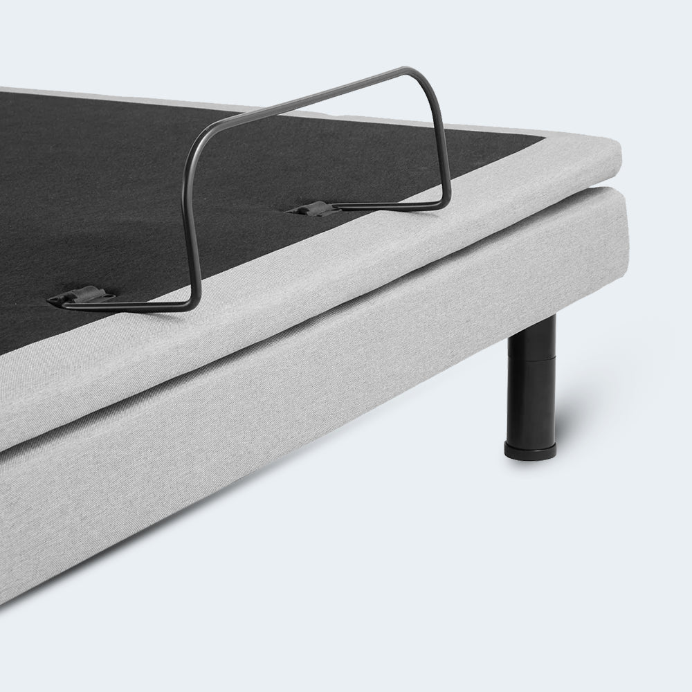 Close-up of the durable metal mattress retainer bar at the foot of the upholstered Malouf S755 adjustable bed foundation.
