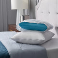 Malouf Prime pillow protector being used to encase a blue pillow for spill and allergen defense.
