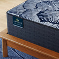 Overhead view of the black and white floral patterned quilted cover on the Serta Excelled Extra Firm mattress.
