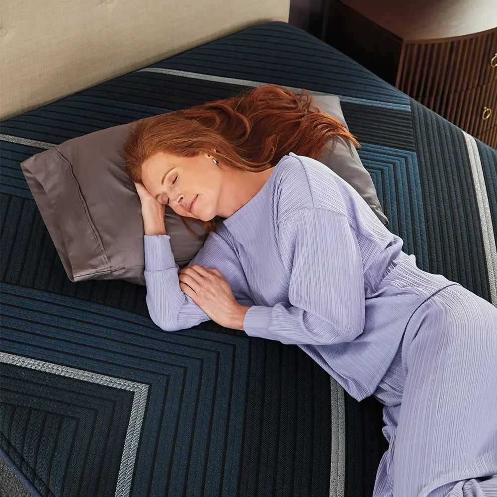 Side sleeper resting on a Beautyrest World Class Hybrid Medium Pillow Top mattress for pressure relief.
