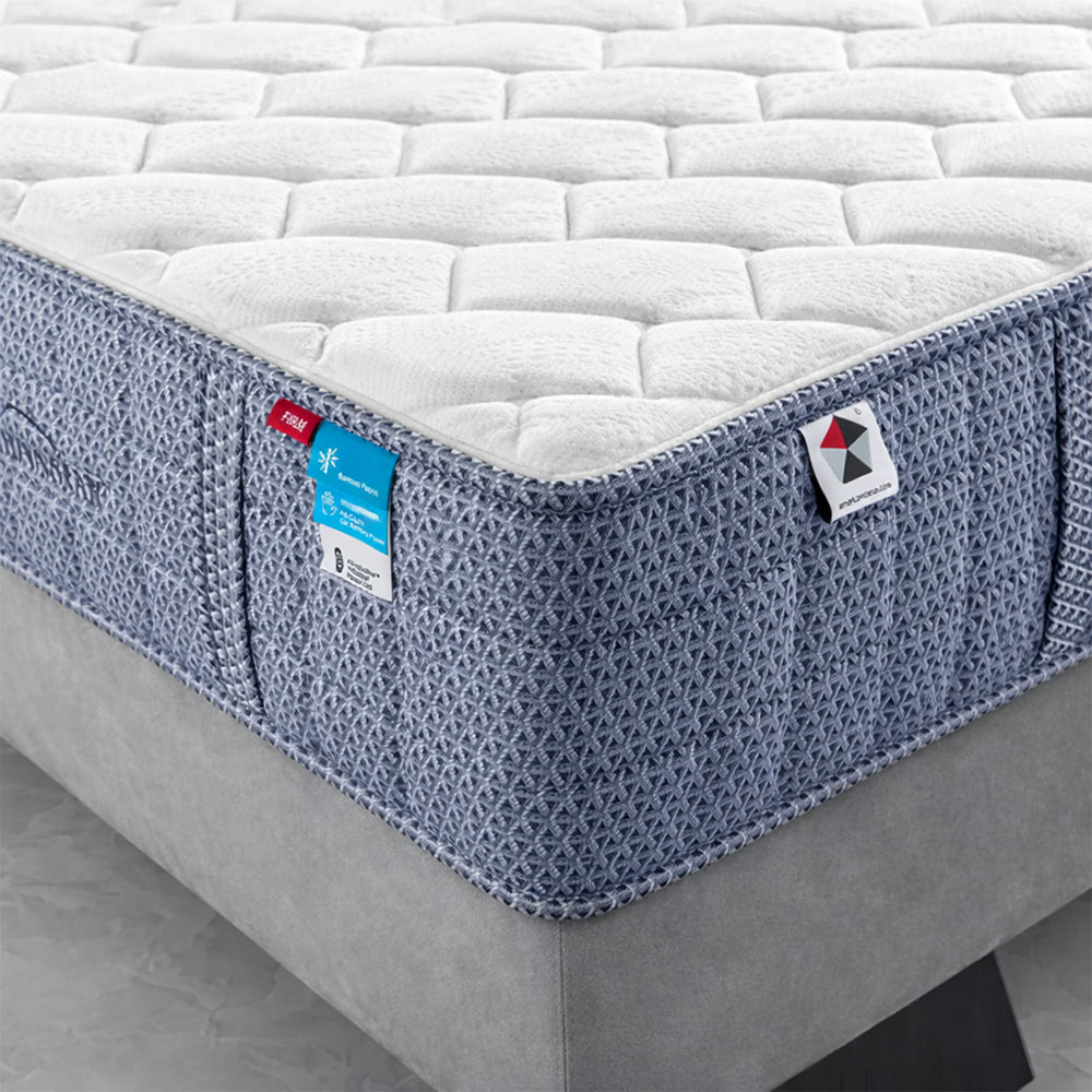 Detailed close-up of the Americanstar Bluesky firm mattress corner showing the honeycomb quilted surface and premium fabric layers.
