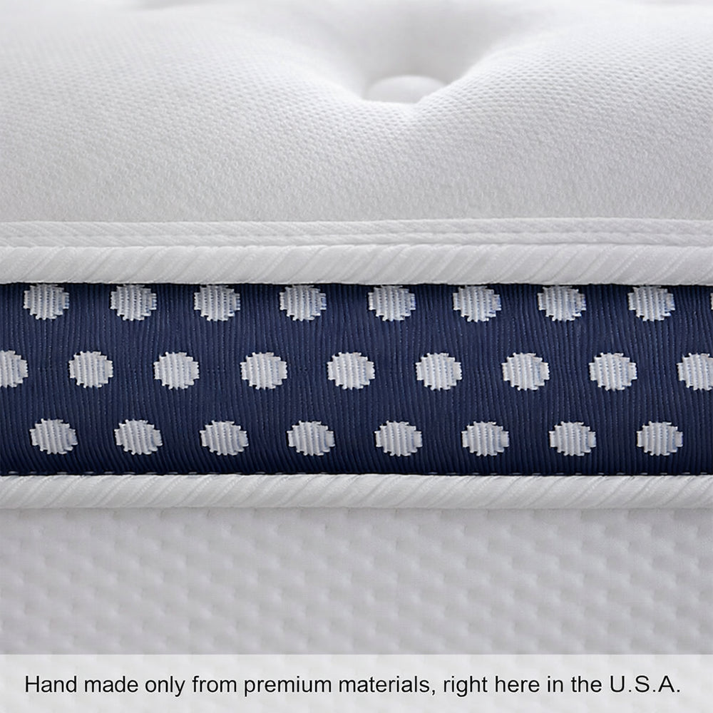 Close-up macro view of the navy blue and white polka dot border of a WinkBed mattress handcrafted from premium American materials.
