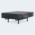 Side perspective of the 13-inch Ashley Firm Hybrid mattress shown on an adjustable power base illustrating flexibility and motion isolation.
