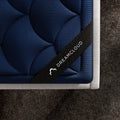 Close-up view of the luxury navy blue quilted performance fabric on the DreamCloud Ultra mattress, optimized for temperature regulation.
