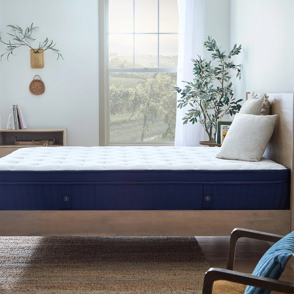 Side view of the 13-inch Weekender hybrid mattress highlighting its high-density foam layers and supportive innerspring coil base.
