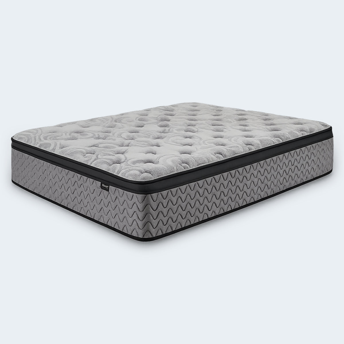 Angled view of the Augusta 12 inch Firm Pillow Top Mattress with a white tufted cover and grey wavy side panels.