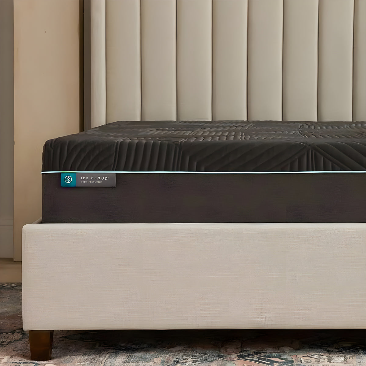 Side angle view of the 14 inch Coolsync Hybrid Mattress styled on a cream upholstered bed in a master bedroom.