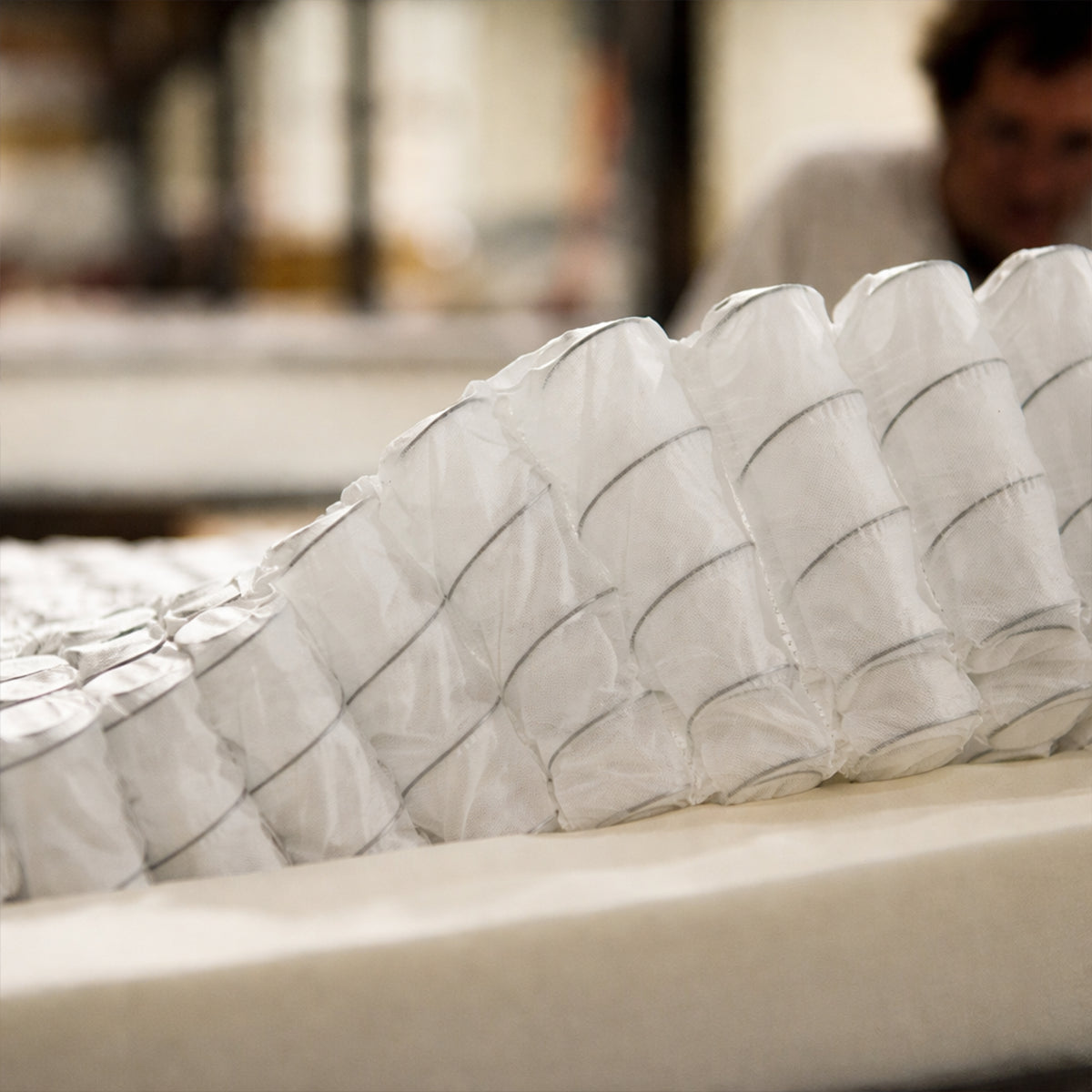 Macro view of the WinkBeds Blue wrapped coil internal system designed for targeted luxury firm back support.