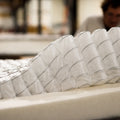 Macro view of the WinkBeds Blue wrapped coil internal system designed for targeted luxury firm back support.