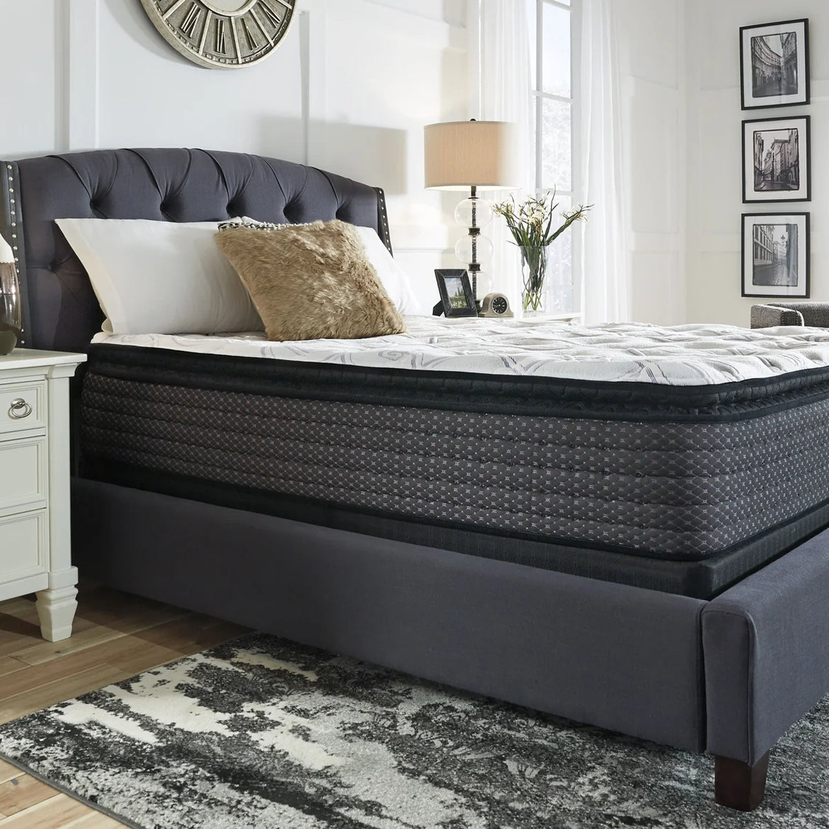 Side profile of the 13.5 Inch Pillow Top Mattress on a modern upholstered bed frame in a master bedroom setting.