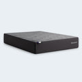Isolated angled profile of the Malouf Neve 12-inch all-foam mattress showcasing its high-profile design and breathable grey geometric cover.
